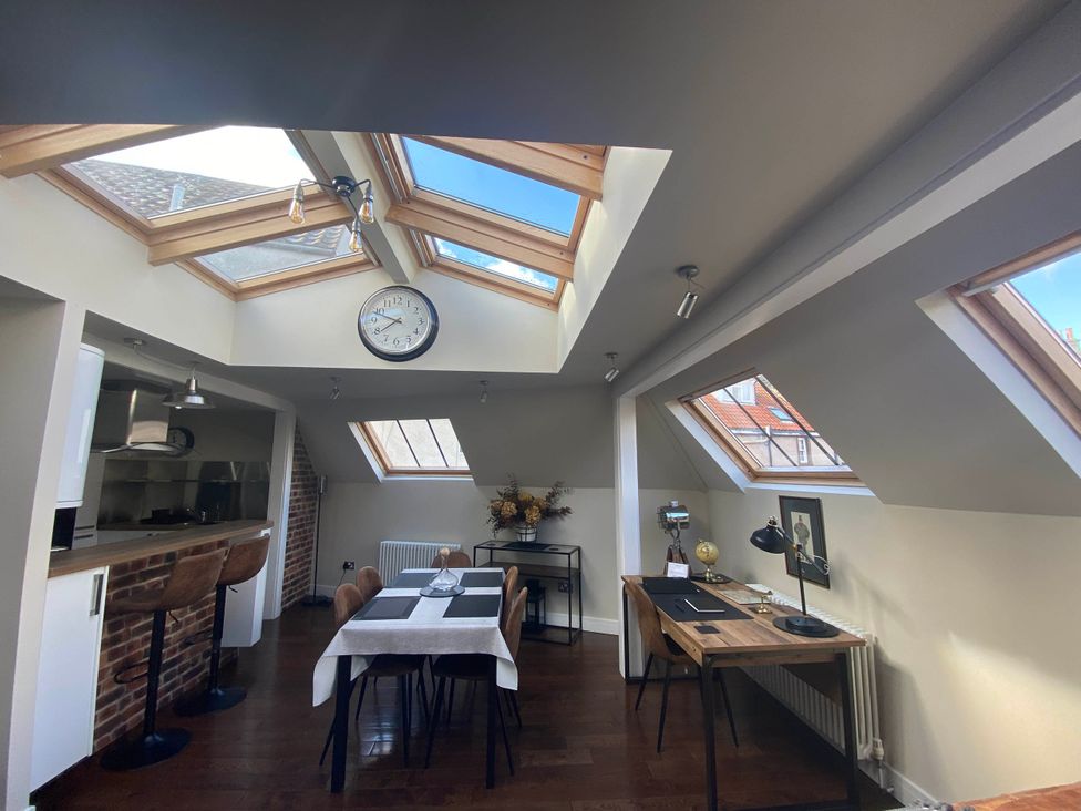 A kitchen with a table and chairs at The Old Barn in Manchester