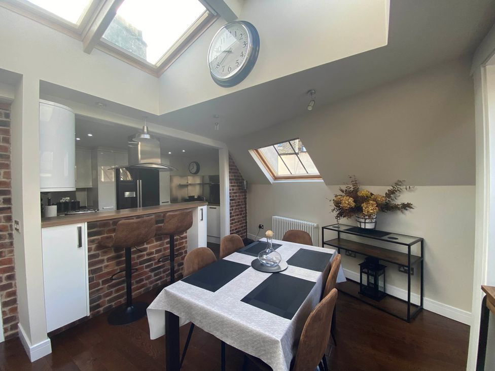 A dining room with a table and chairs at The Old Barn in Manchester