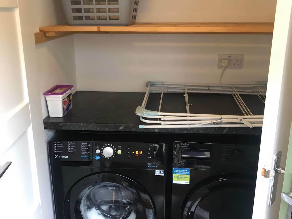 A laundry room with washing machine and dryer at the property