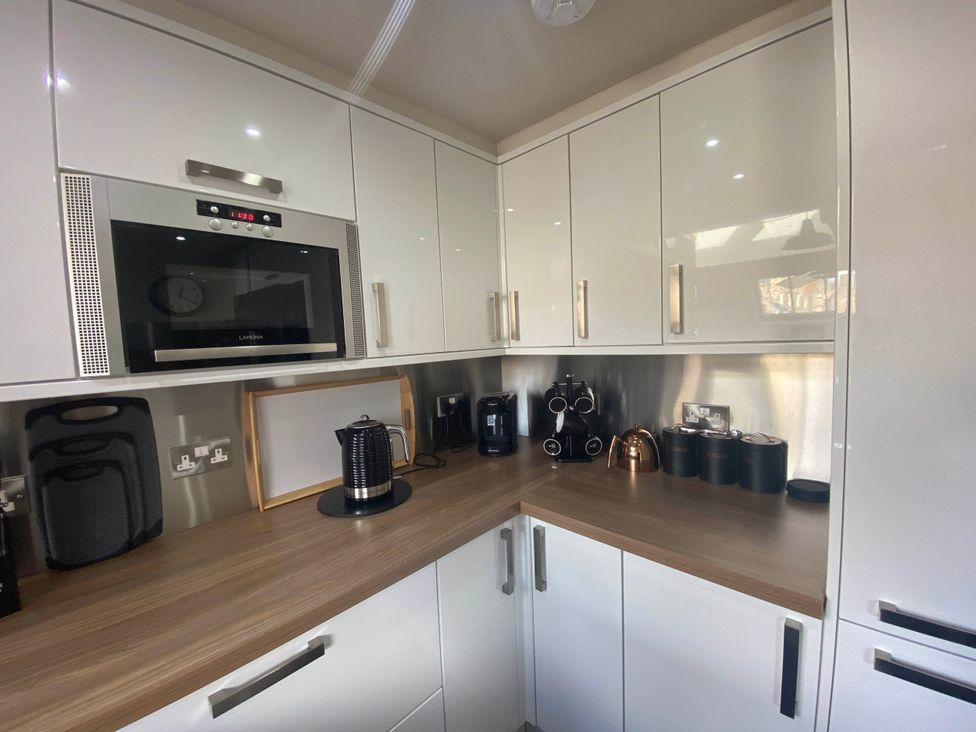 A kitchen with appliances and a wooden countertop at The Old Barn in Manchester