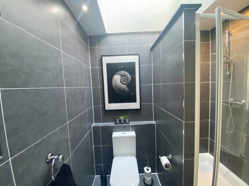 A bathroom with a shower and toilet at the property in the unspecified location