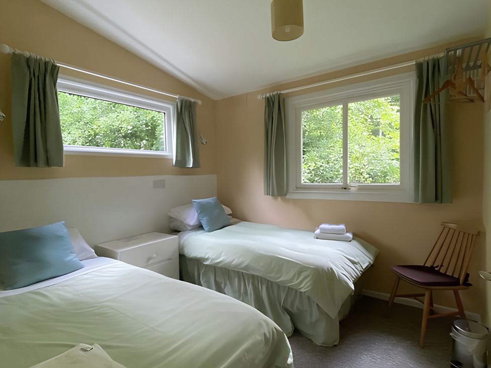 A bedroom with two beds and a window at Baillie Chalet