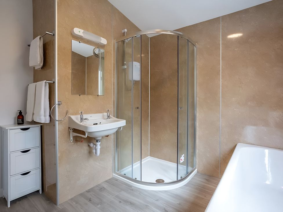 A bathroom with a shower and sink at Kilninver Chalet