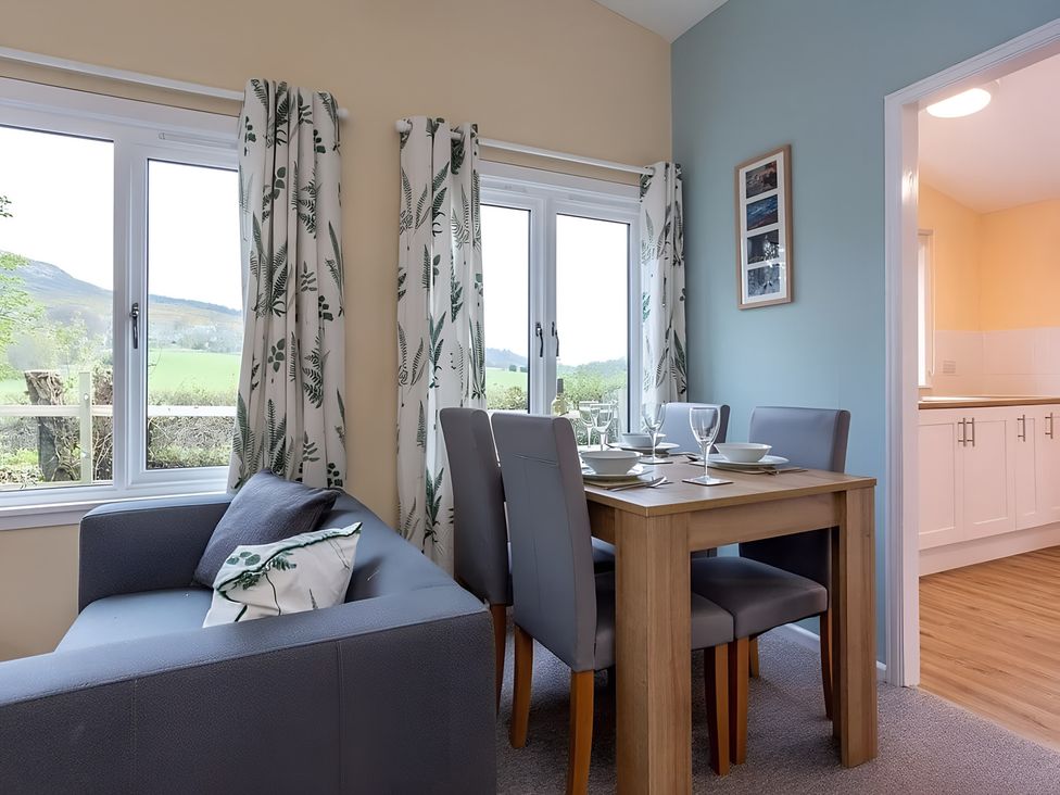 A dining room with a table and chairs at the property in an unspecified location