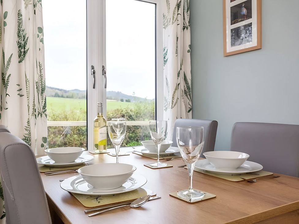 A dining room with a table set for four at The Old Barn in Manchester