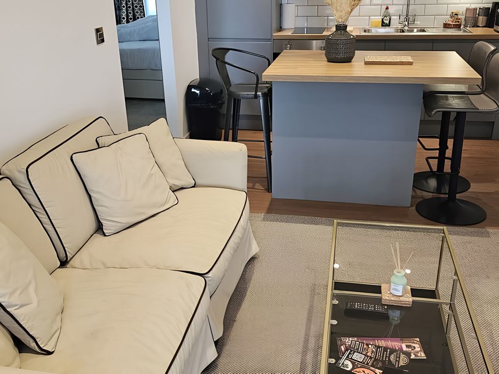 A living room with a sofa and coffee table at Rutland Apartment