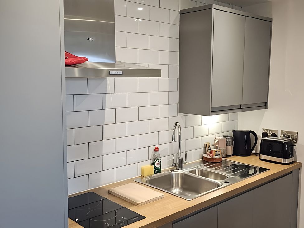 A kitchen with a sink and cooker at Rutland Apartment 