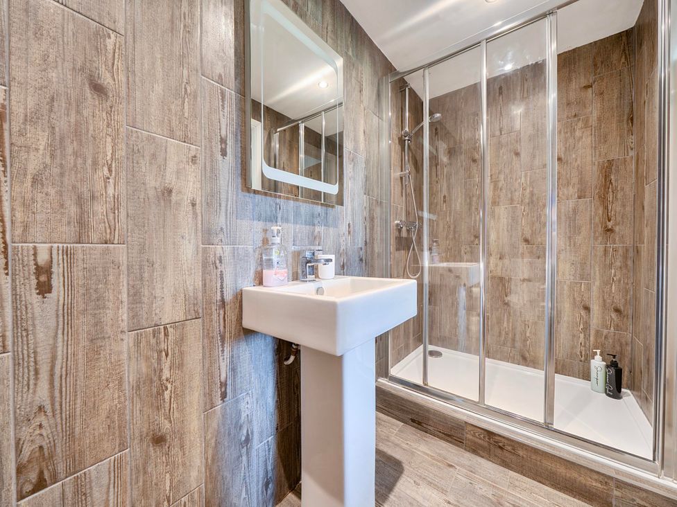 A bathroom with a sink and shower at Rutland Apartment in Morcott