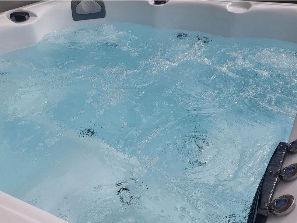 A hot tub filled with water at Old Highwood Barns Dunkeswell