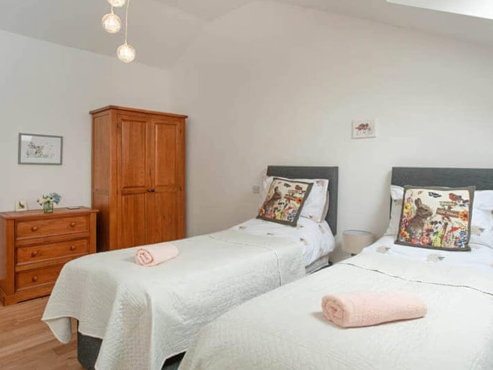 A bedroom with two beds and furniture at the property in location