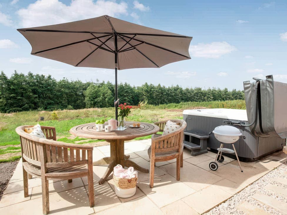 An outdoor seating area with a table and chairs at a property