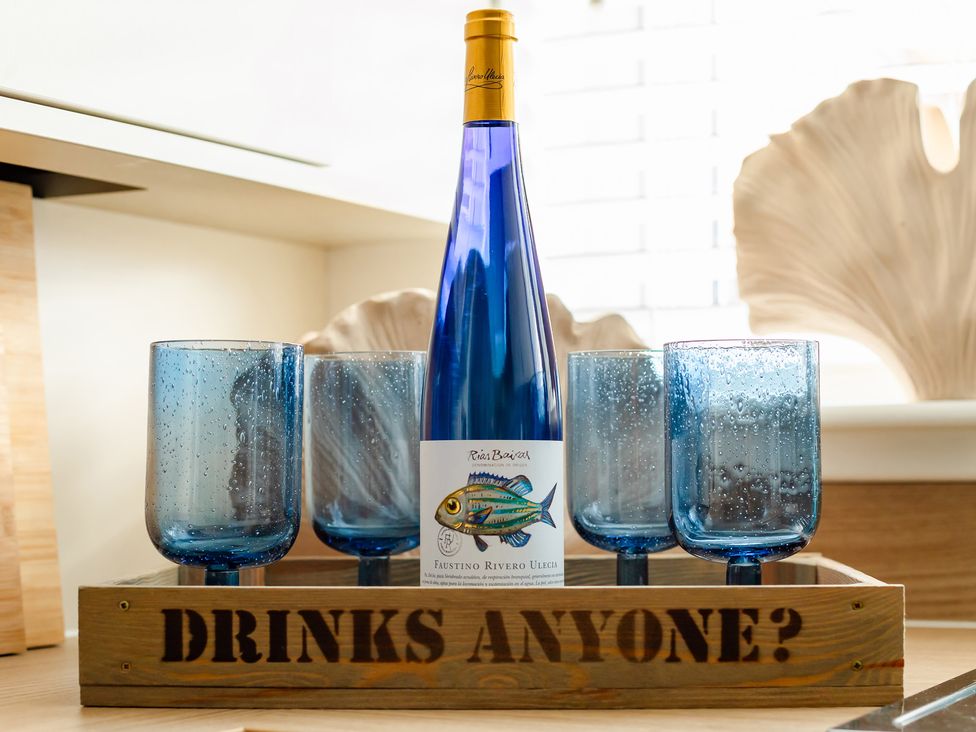 A bottle and glasses on a tray at Wee Jules By The Sea