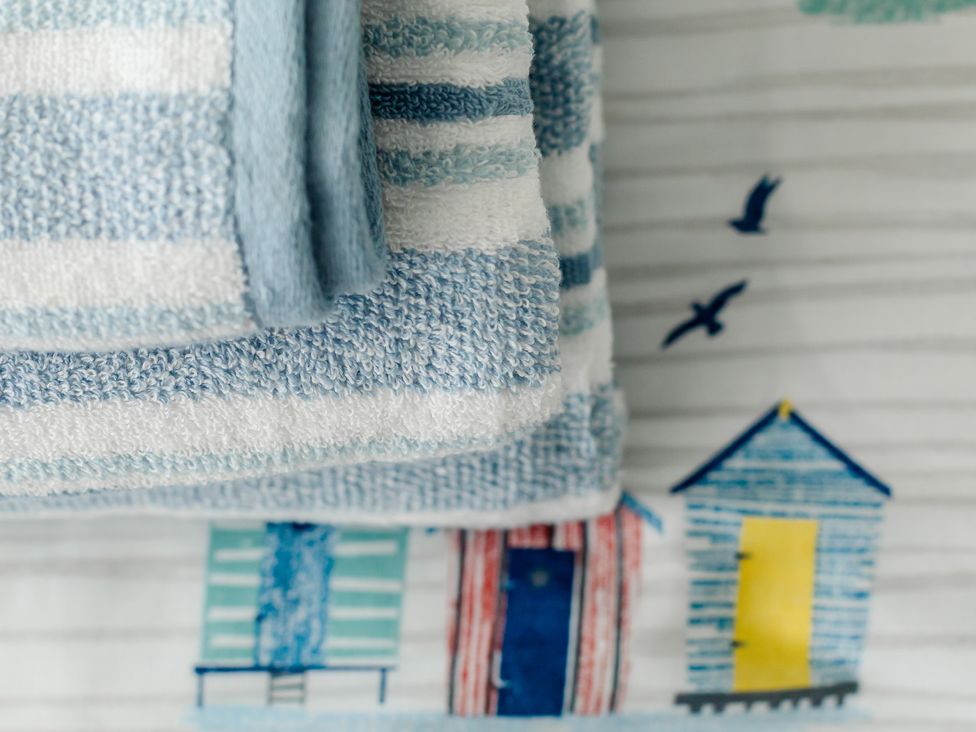 A stack of towels on a patterned surface at Wee Jules By The Sea