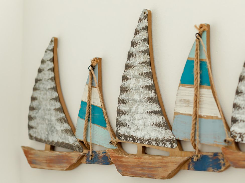 Decorative wooden sailboats on wall at Wee Jules By The Sea