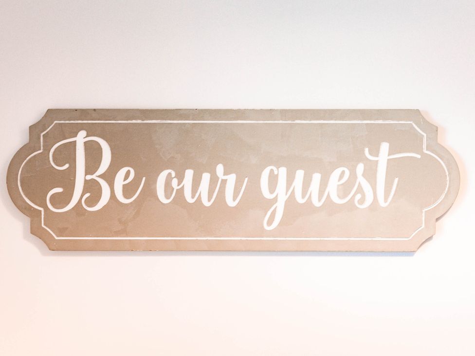 A decorative sign saying Be our guest