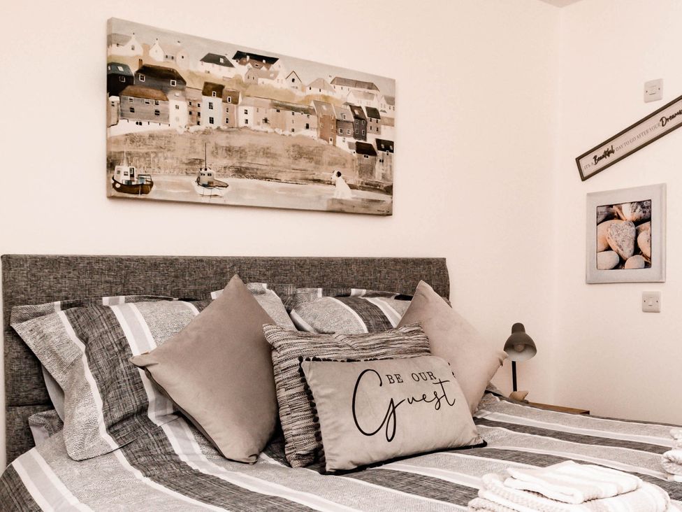 A bedroom with a bed and decorative pillows at 