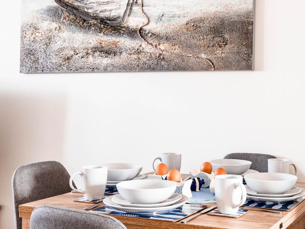 A dining room table set with bowls and cups at the property in 