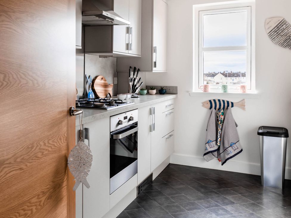A kitchen with oven, stove, and window at The Old Barn in Manchester