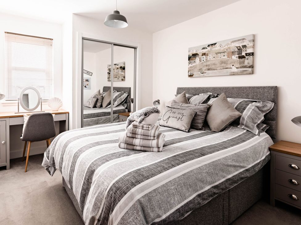A bedroom with a bed and desk at The Old Barn in Manchester