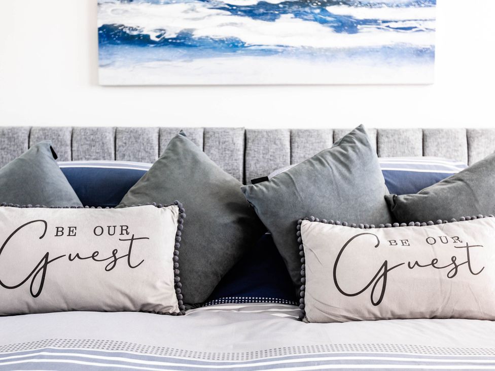 A bed with pillows and wall art at the property in an unspecified location