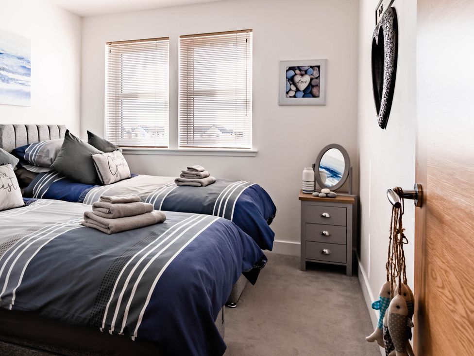 A bedroom with twin beds and a nightstand at 