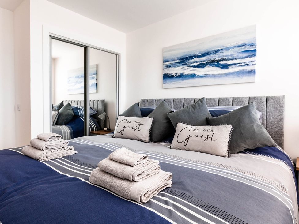 A bedroom with a bed and pillows at 