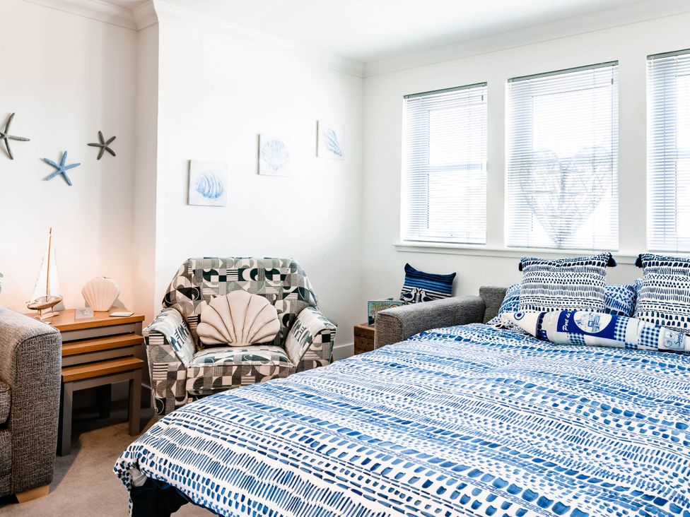 A bedroom with a bed and armchair at The Coastal Retreat in Miami