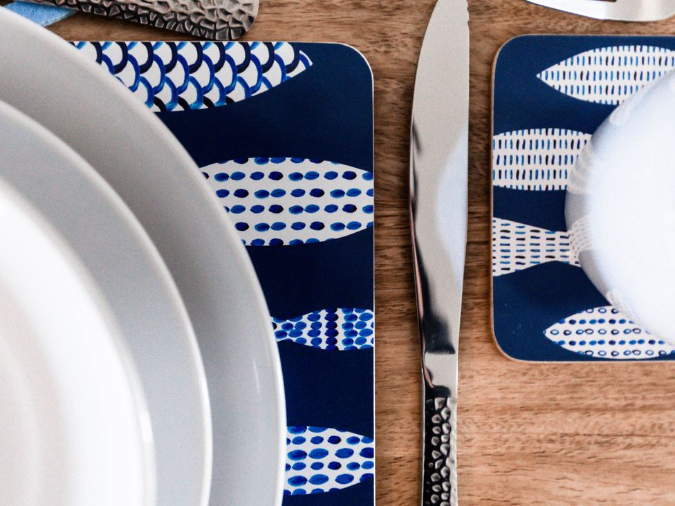 A dining table setting with plates and cutlery at a property