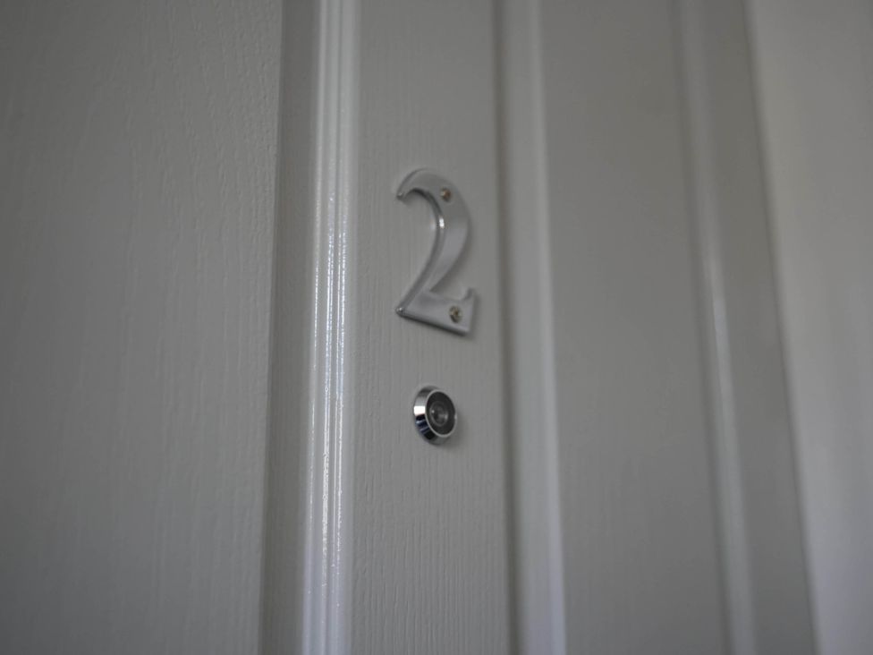 A door with number 2 and a peephole