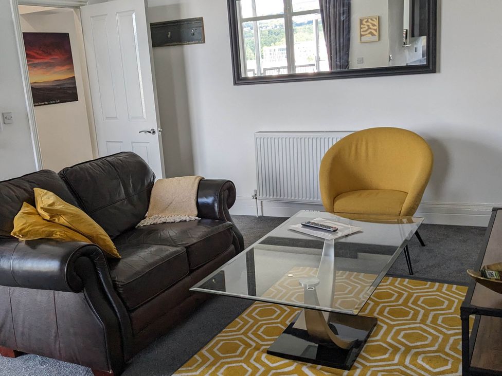 A living room with a sofa and an armchair at the property in location