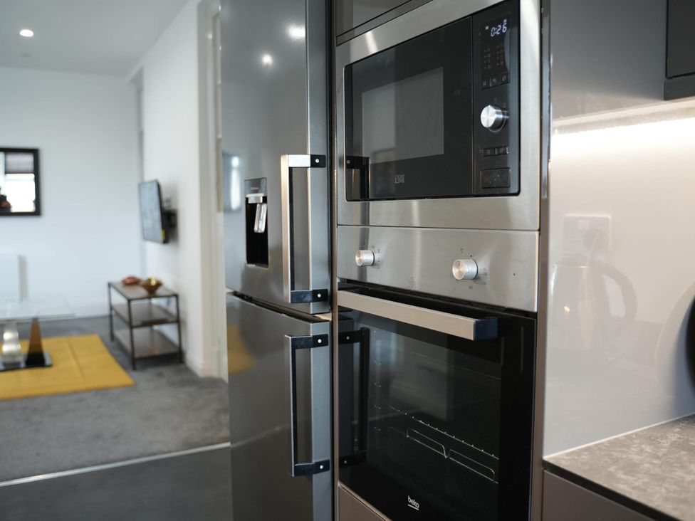 A kitchen with stainless steel appliances and a countertop at The Old Barn in Manchester