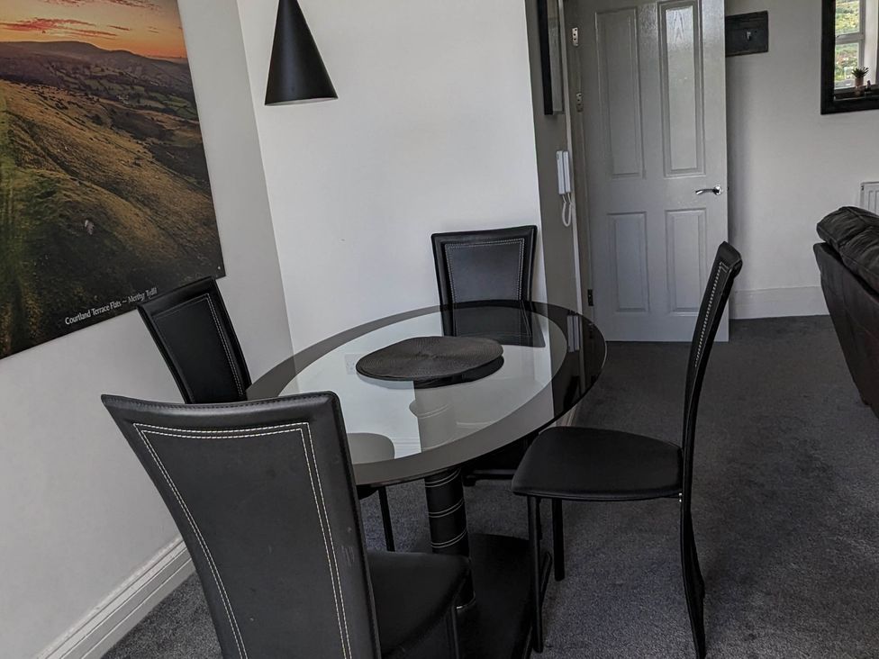 A dining room with a glass table and chairs at a property in 