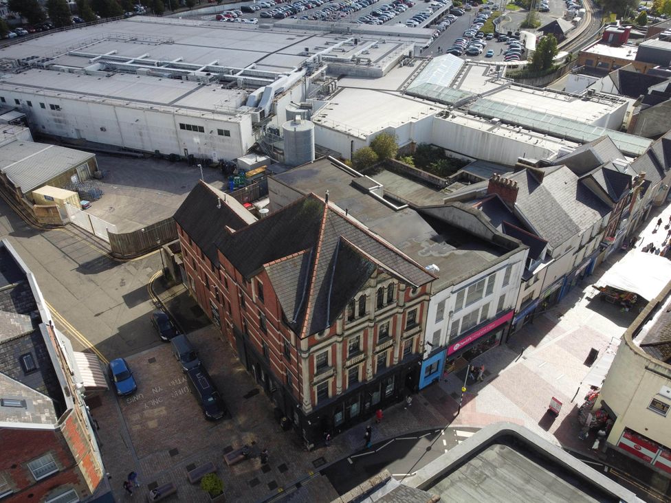 An aerial view of a street with buildings and a parking lot