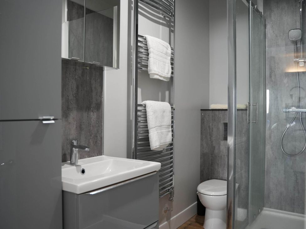 A bathroom with a shower and towel rack at the property