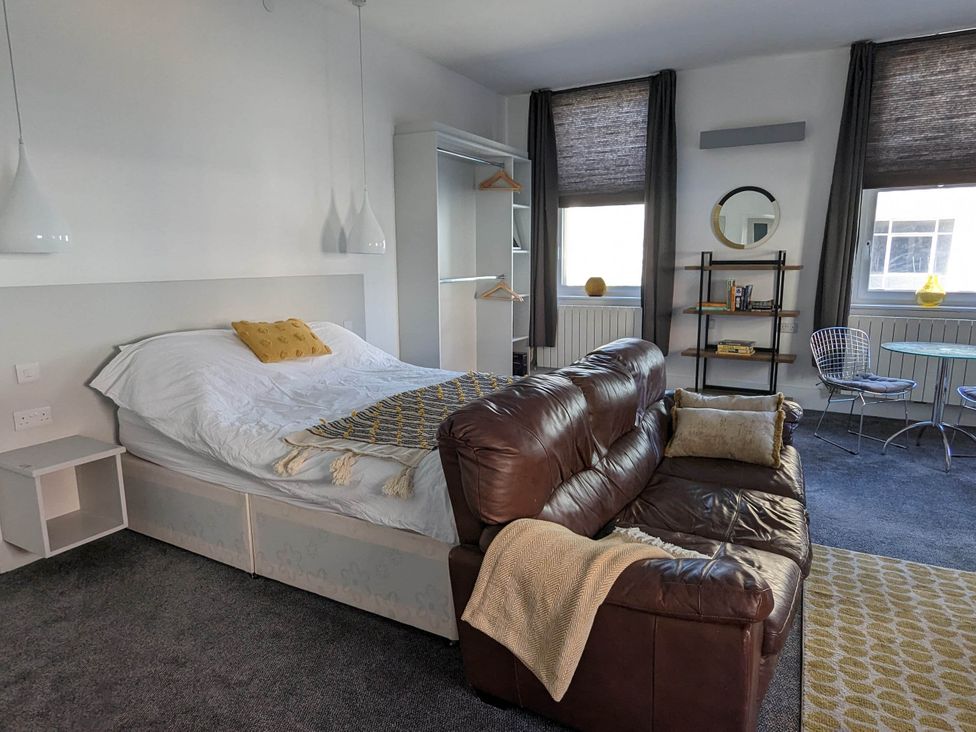 A living room with a bed and sofa at an unspecified location