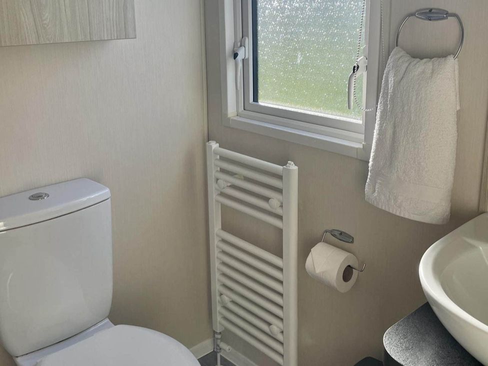 A bathroom with a toilet and sink at the property