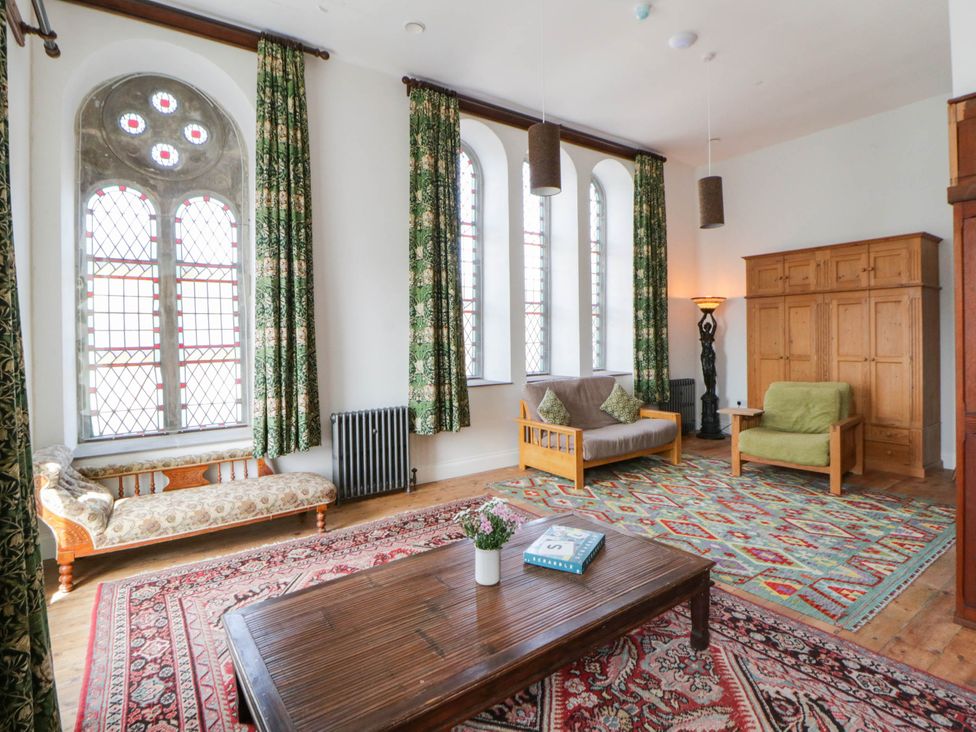 A living room with a sofa and coffee table at Capel Llani in Llanidloes