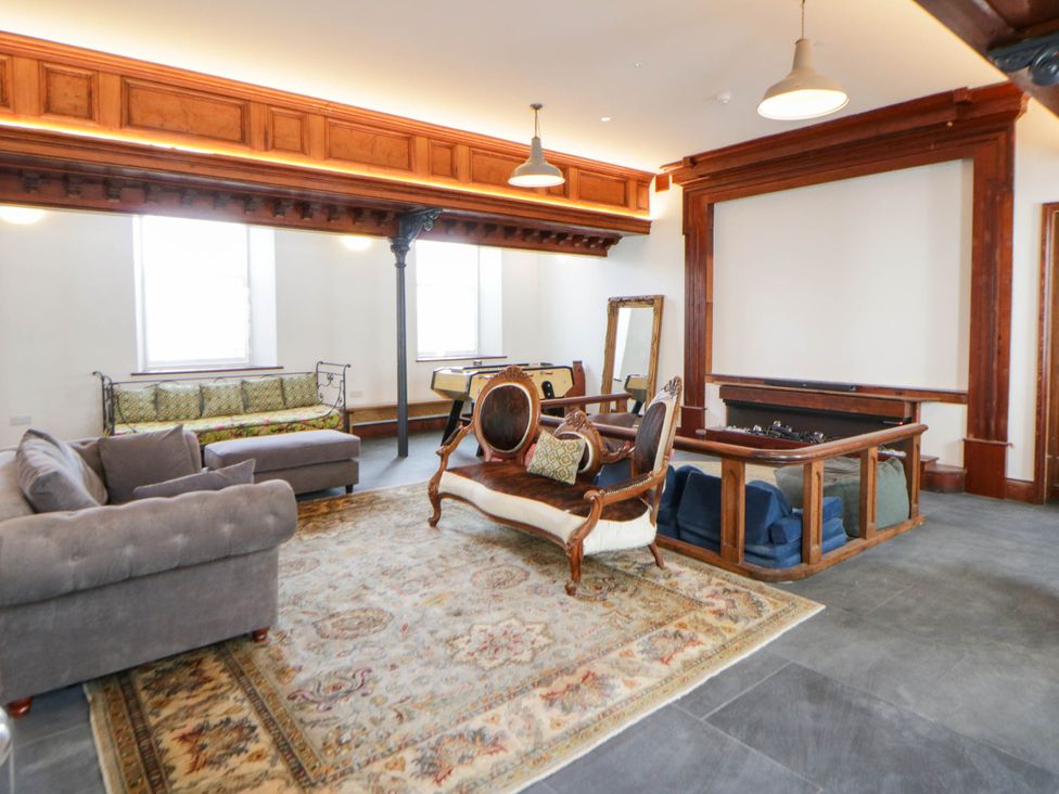 A living room with a pool table and seating area at Capel Llani Llanidloes