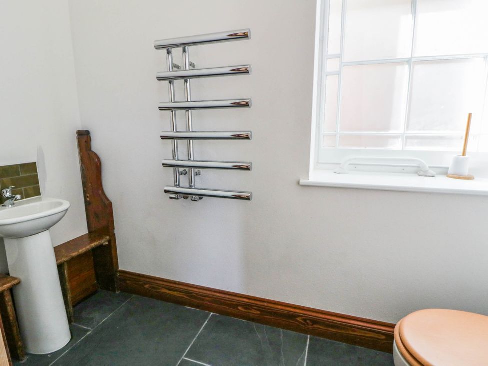 A bathroom with a sink and towel radiator at Capel Llani Llanidloes