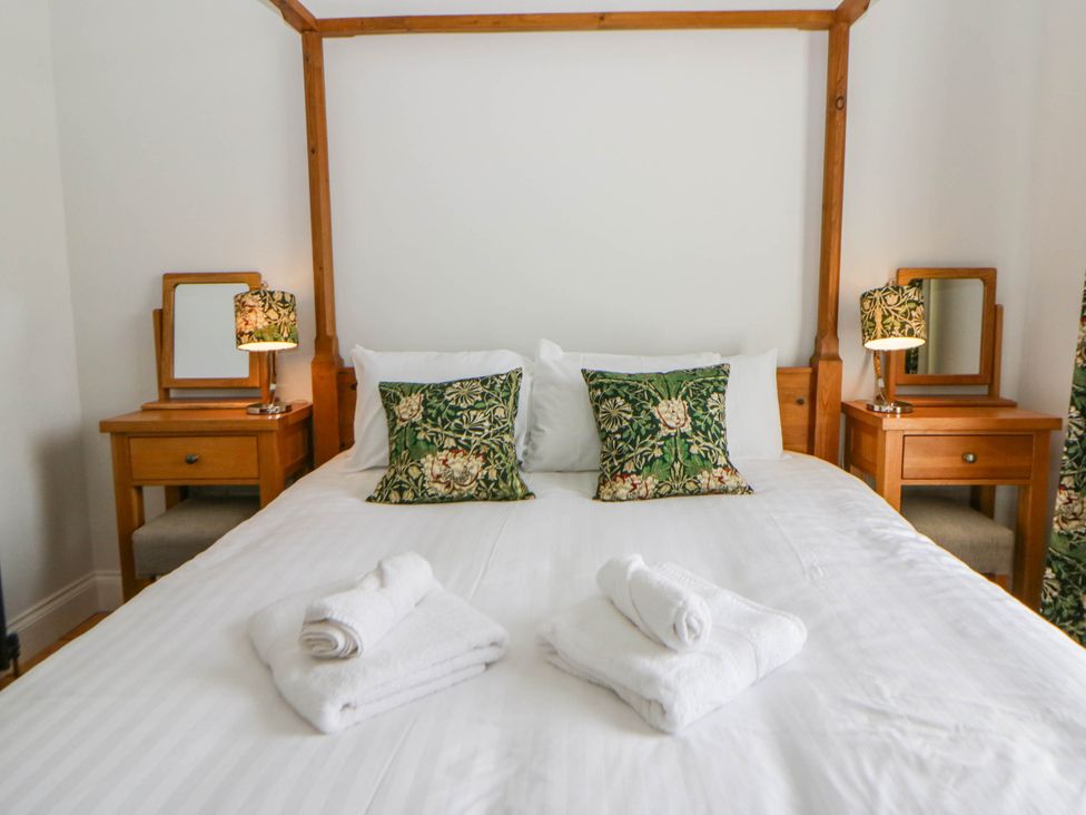 A bedroom with a bed and bedside tables at Capel Llani in Llanidloes