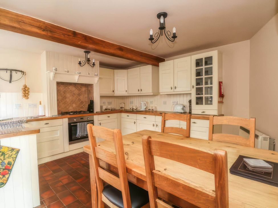 A kitchen with a dining table and chairs at The Old Barn in Manchester
