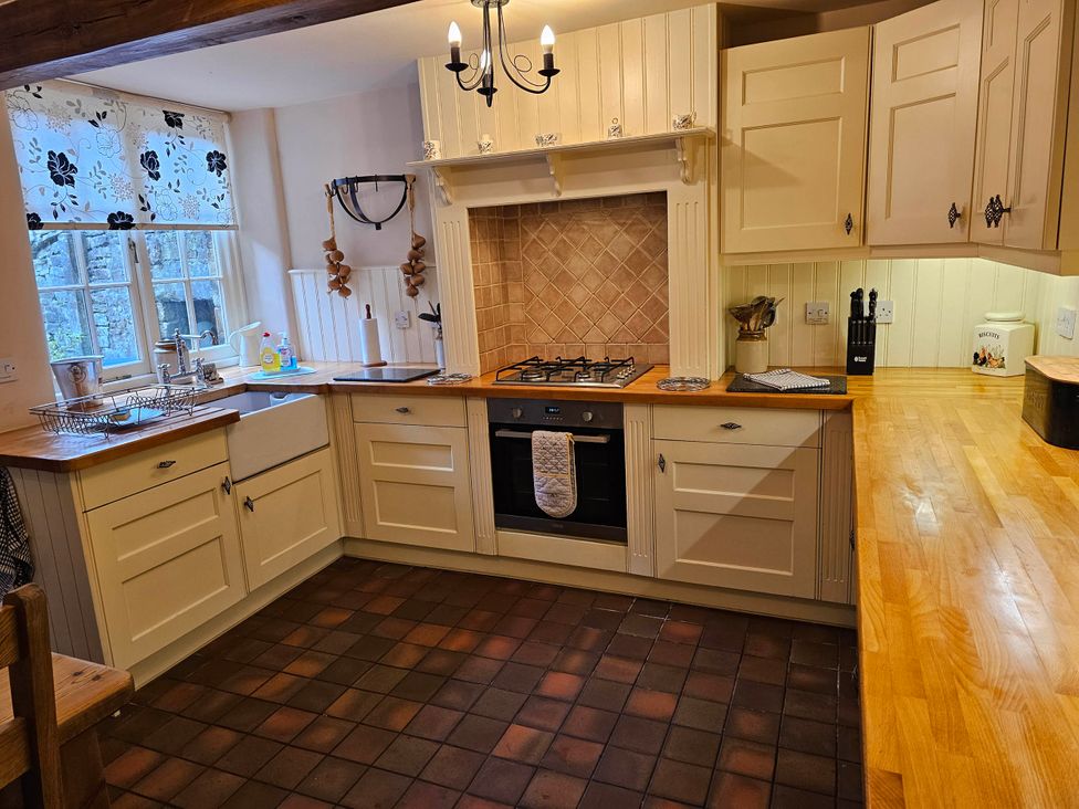 A kitchen with cabinets, a gas stove, and a sink at the property.