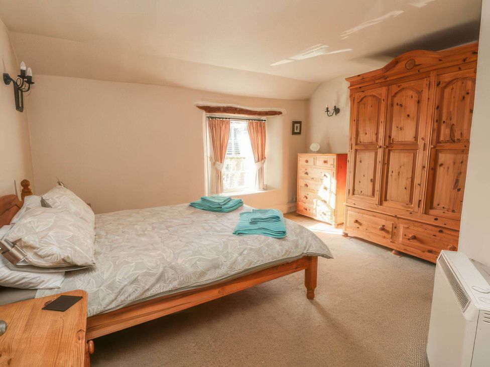 A bedroom with a bed and wardrobe at The Old Barn in Manchester