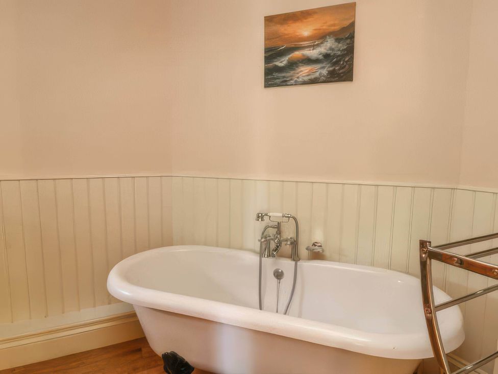 A bathroom with a bathtub and faucet at the property in location
