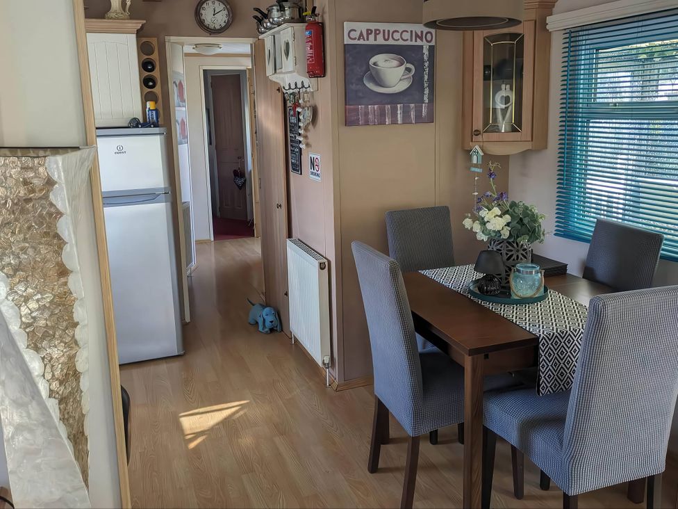 A dining room with a table and chairs at the property in the unspecified location