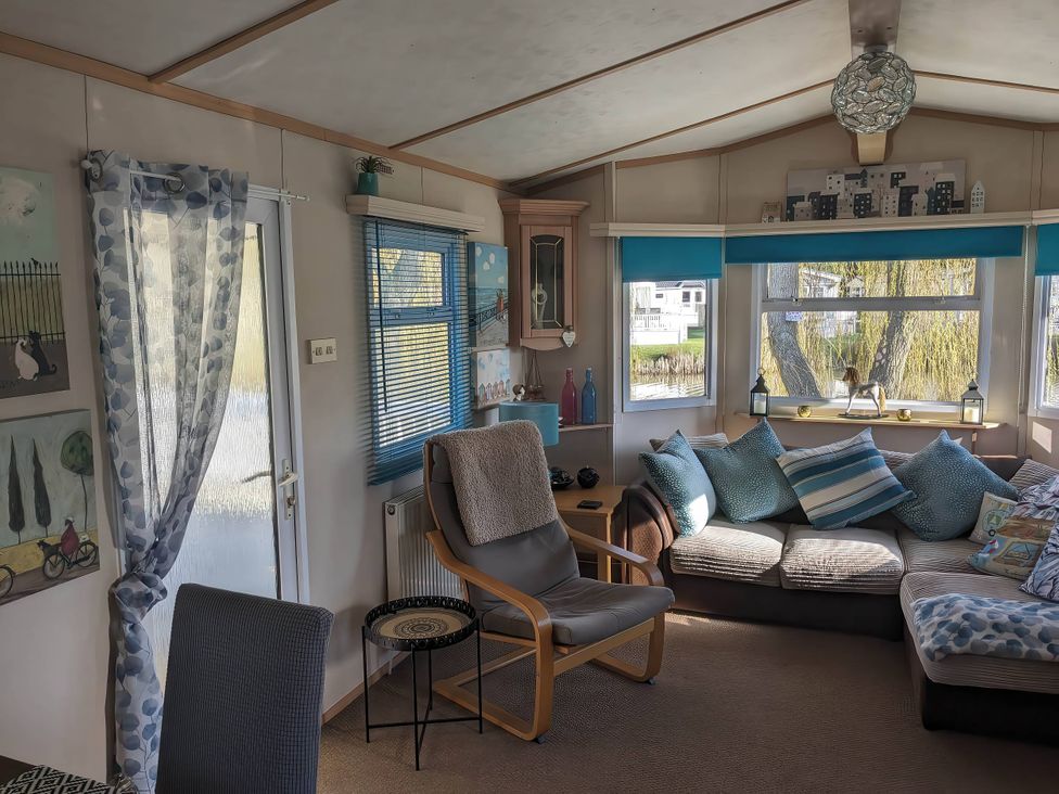 A living room with a sofa and chair at the property in the image