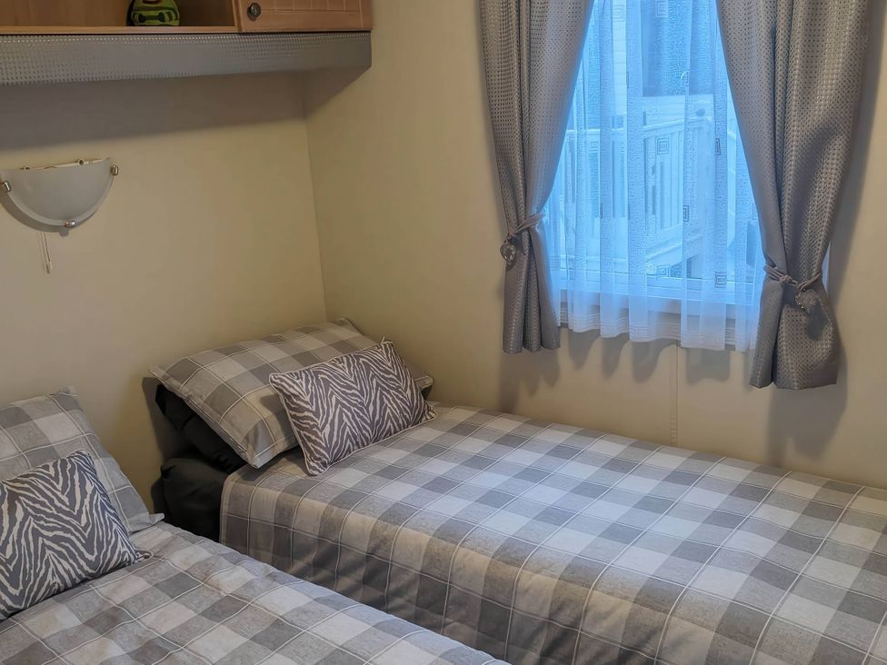 A bedroom with two single beds and a window at 