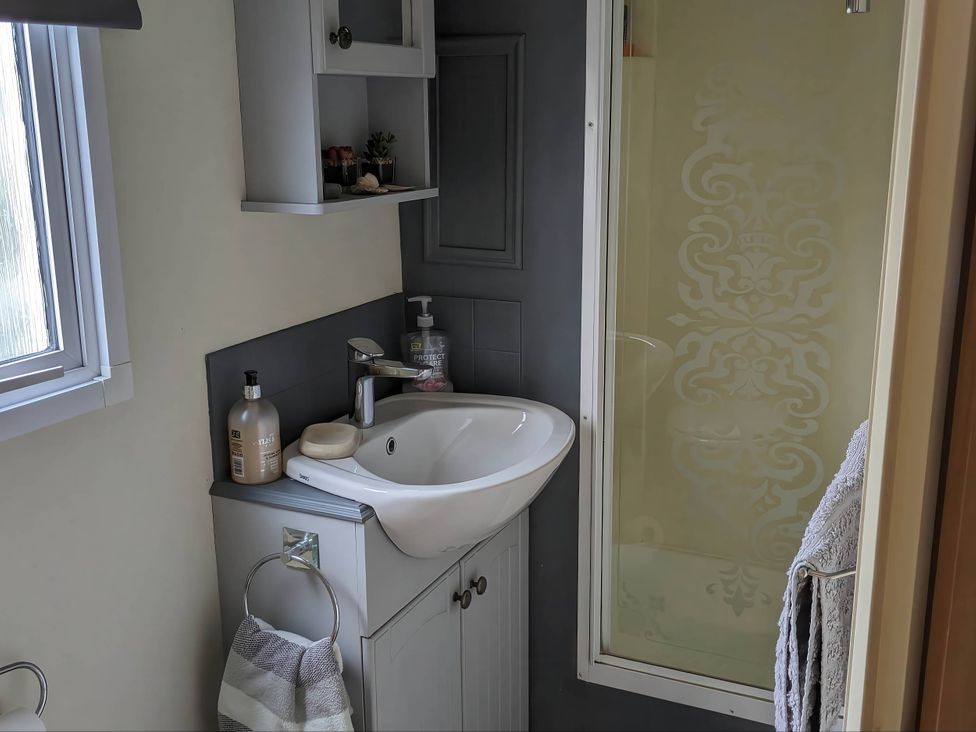 A bathroom with a sink and shower at 