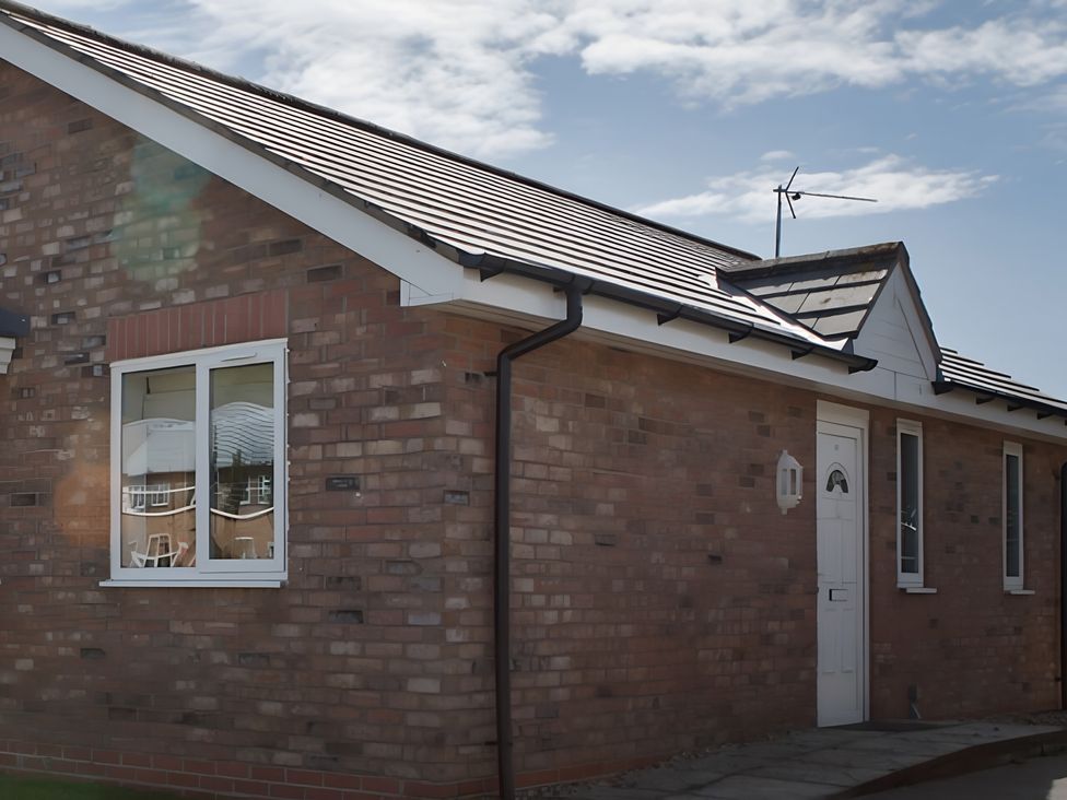 An exterior view of a house with a door and windows at Ivy Corner