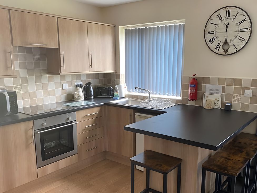 A kitchen with cabinets and appliances at Ivy Corner